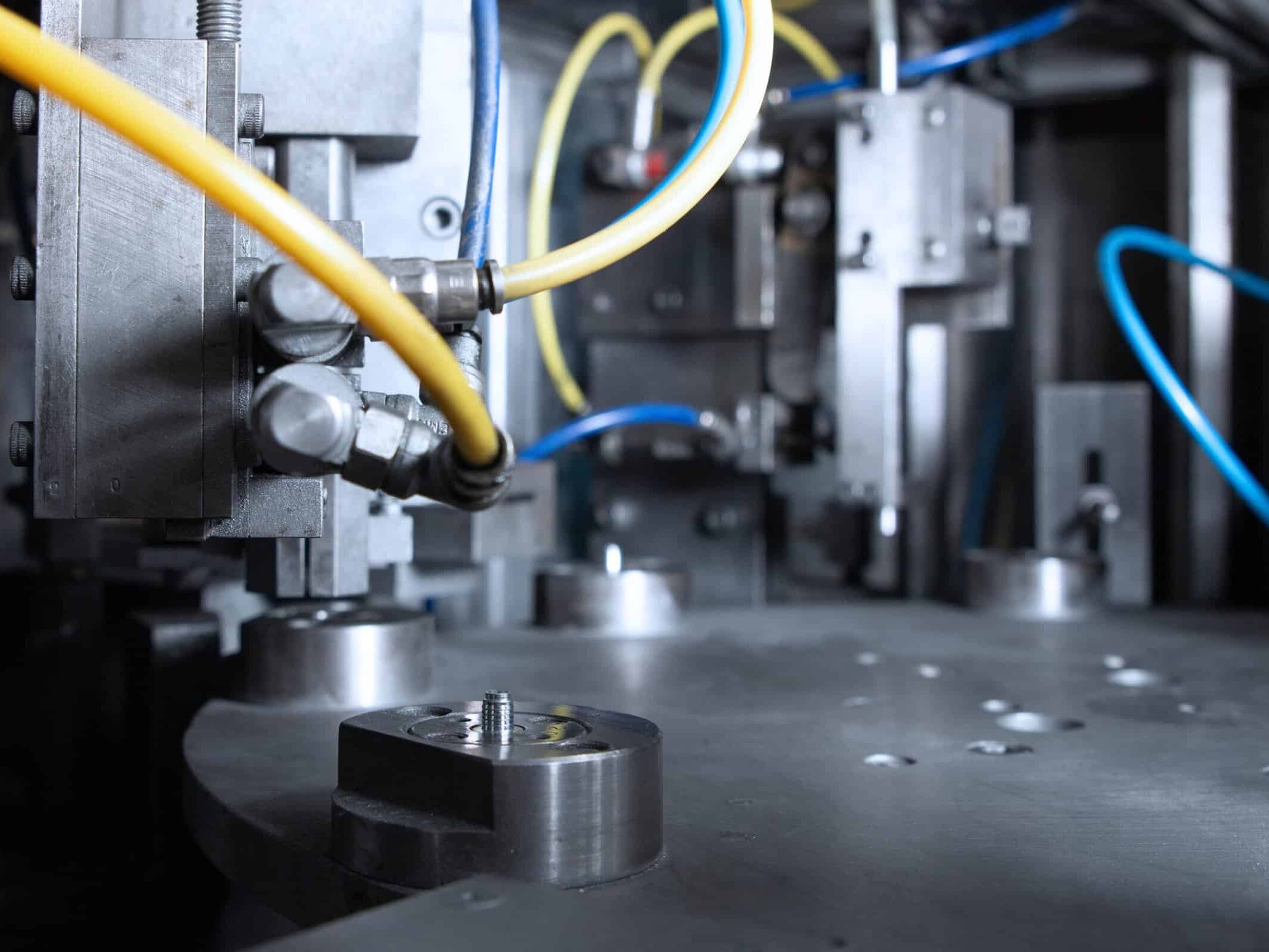 Close-Up Of A Machine With Pipes And Screws